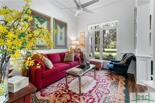 living room featuring hardwood / wood-style flooring, crown molding, and ceiling fan