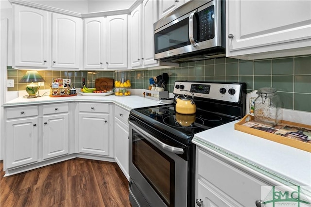 kitchen with appliances with stainless steel finishes, white cabinets, and decorative backsplash