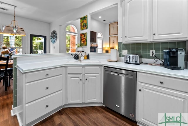 kitchen with dark hardwood / wood-style floors, white cabinetry, dishwasher, sink, and kitchen peninsula