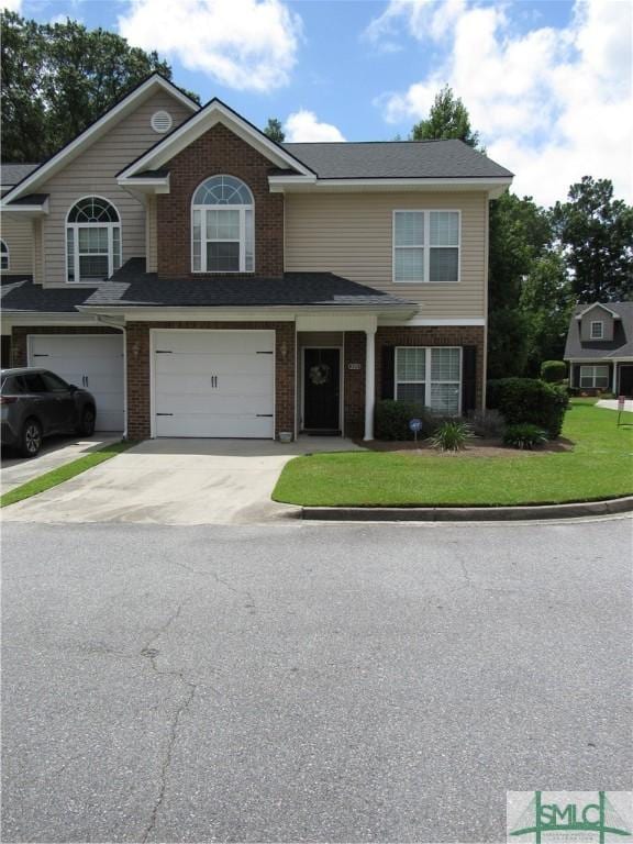 view of front facade featuring a garage and a front lawn