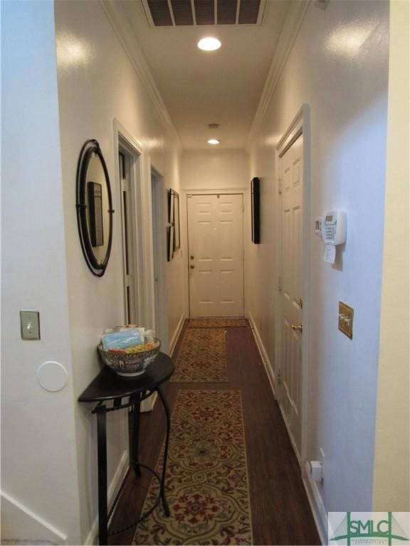 hallway with crown molding and dark wood-type flooring