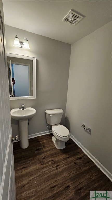 bathroom featuring toilet and hardwood / wood-style flooring