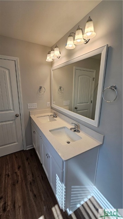 bathroom with hardwood / wood-style flooring and double sink vanity