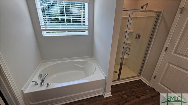 bathroom featuring hardwood / wood-style floors and separate shower and tub