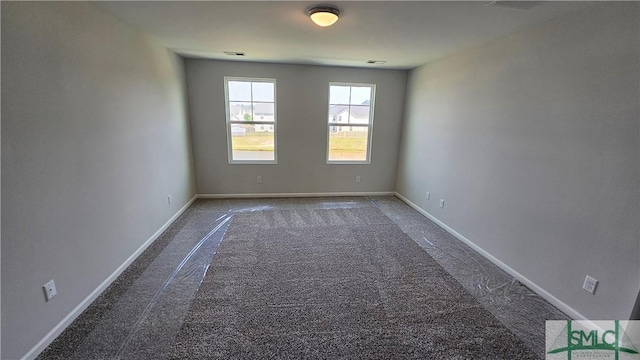 carpeted empty room with visible vents and baseboards