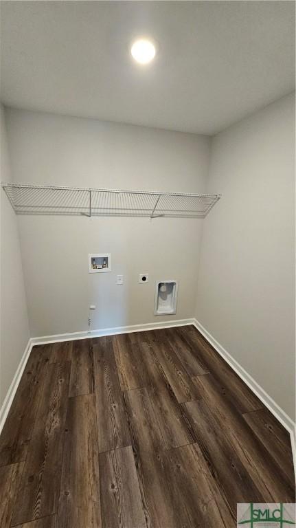 washroom featuring laundry area, electric dryer hookup, washer hookup, dark wood-style flooring, and baseboards