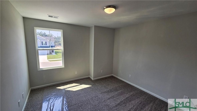 unfurnished room with baseboards, visible vents, and carpet floors