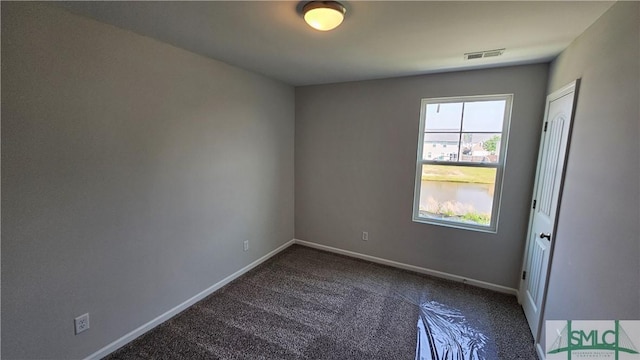 unfurnished room featuring visible vents, baseboards, and carpet floors