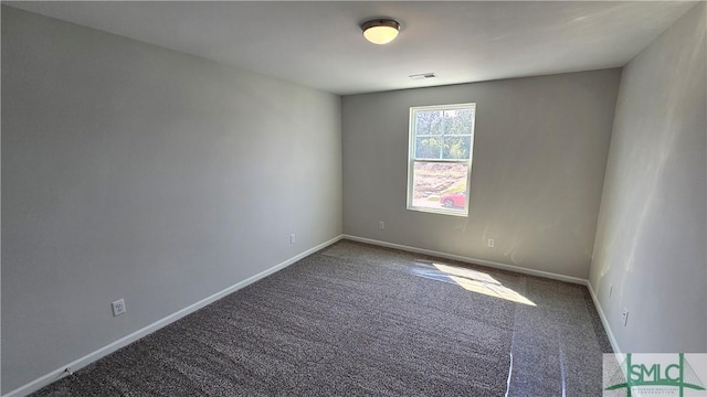 carpeted empty room with visible vents and baseboards