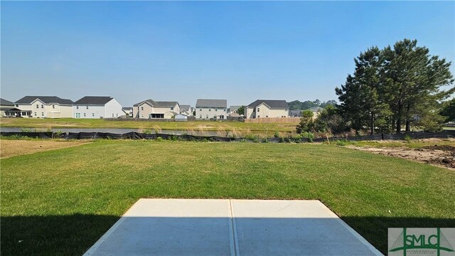 view of yard featuring a patio area and a residential view