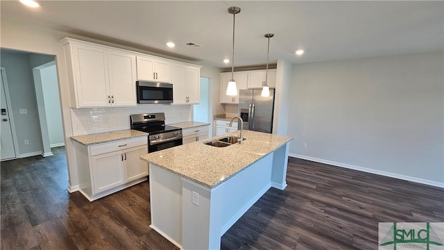 kitchen with a sink, dark wood-style floors, visible vents, and stainless steel appliances
