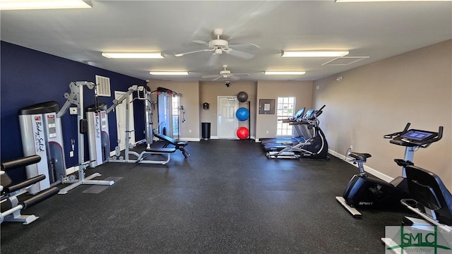 exercise room featuring baseboards and a ceiling fan