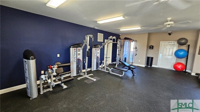 workout area featuring baseboards and a ceiling fan