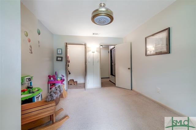 recreation room featuring light colored carpet