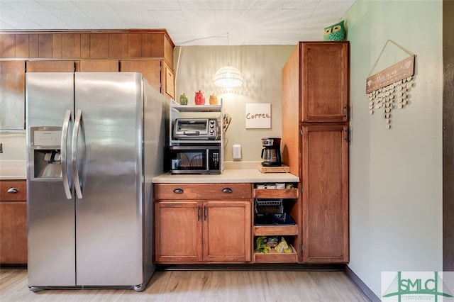 kitchen featuring light hardwood / wood-style flooring and appliances with stainless steel finishes