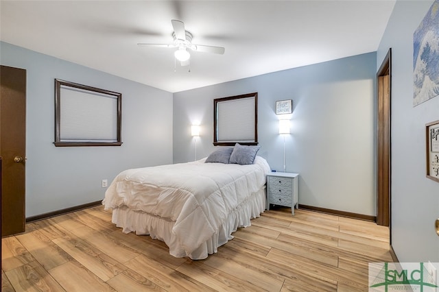 bedroom with ceiling fan and light hardwood / wood-style flooring