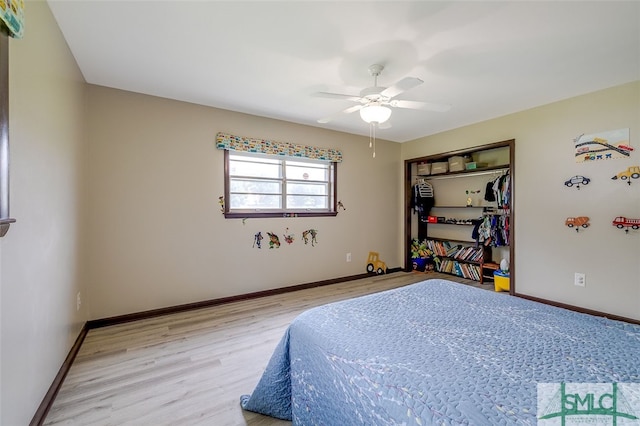 bedroom with light hardwood / wood-style flooring, a closet, and ceiling fan