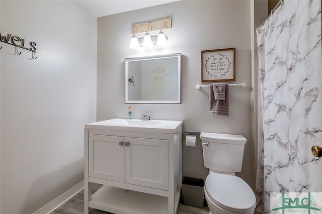 bathroom with hardwood / wood-style floors, toilet, and vanity