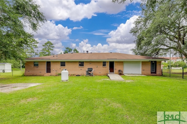 rear view of property featuring a yard