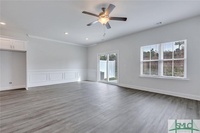 empty room with dark hardwood / wood-style flooring and ceiling fan