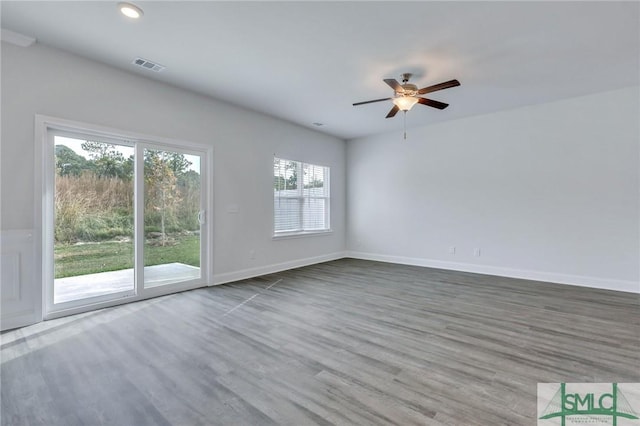 spare room with ceiling fan and wood-type flooring