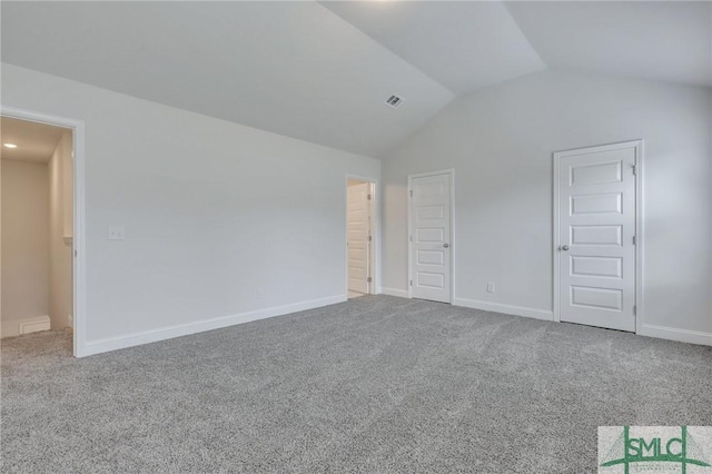 unfurnished bedroom with carpet and vaulted ceiling