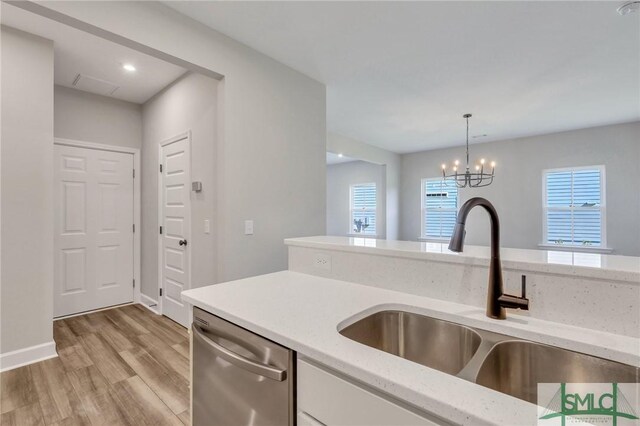 kitchen with hanging light fixtures, dishwasher, plenty of natural light, and sink