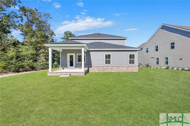 rear view of house featuring a patio area and a lawn