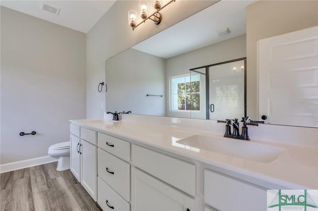 bathroom with walk in shower, toilet, an inviting chandelier, wood-type flooring, and vanity