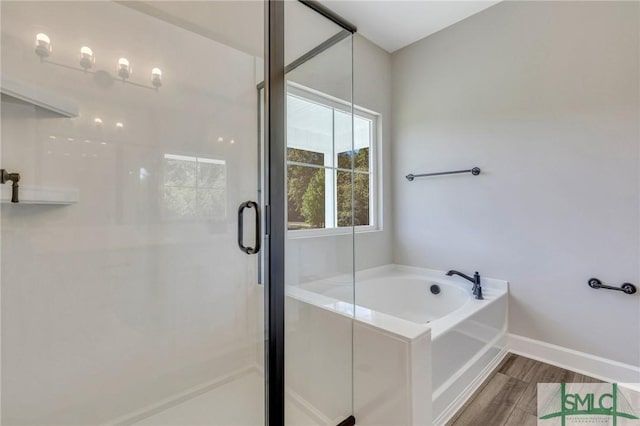 bathroom featuring hardwood / wood-style flooring and separate shower and tub