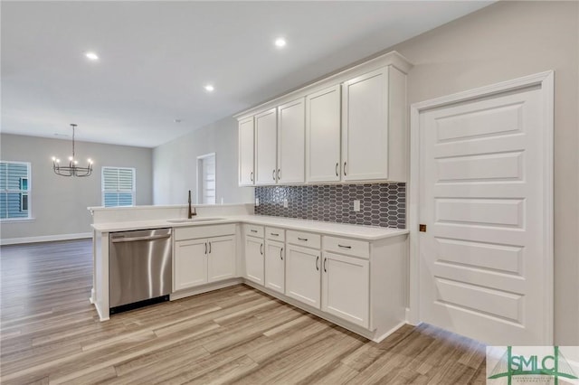 kitchen with white cabinetry, dishwasher, sink, and pendant lighting