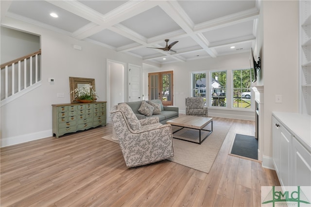 living room featuring ornamental molding, coffered ceiling, ceiling fan, beam ceiling, and light hardwood / wood-style floors