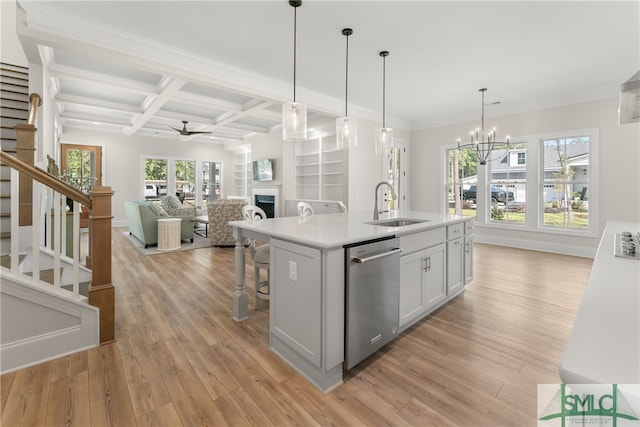 kitchen with white cabinets, sink, dishwasher, light hardwood / wood-style floors, and an island with sink