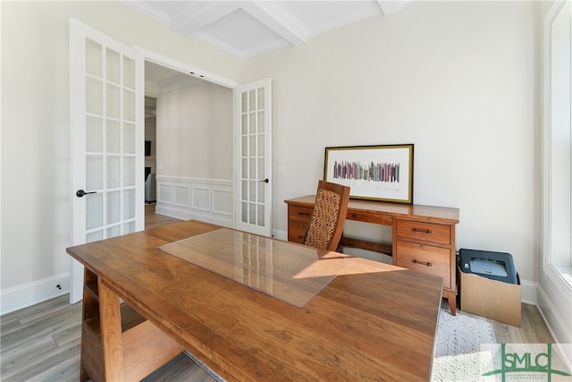 office featuring beamed ceiling, light hardwood / wood-style floors, and french doors