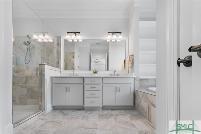 bathroom with separate shower and tub, vanity, and ornamental molding