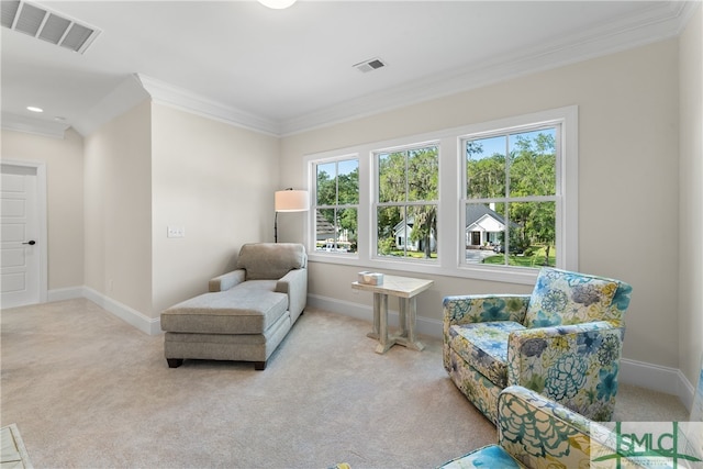 living area with light carpet, a wealth of natural light, and ornamental molding