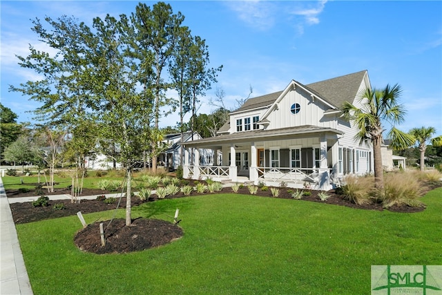 view of front of home featuring a front lawn and covered porch