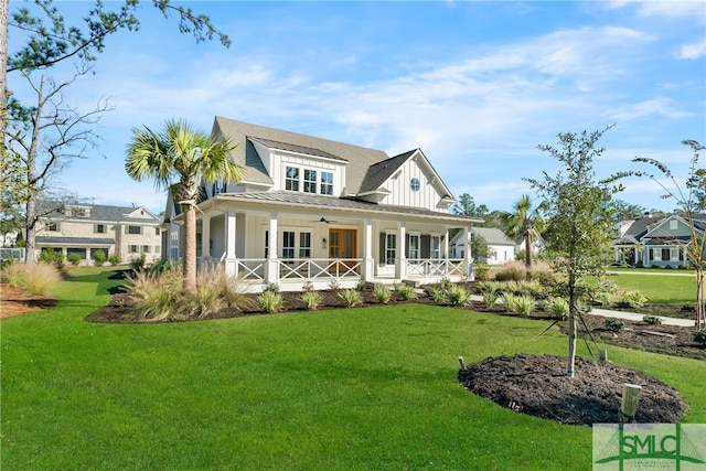 view of front facade featuring covered porch and a front yard