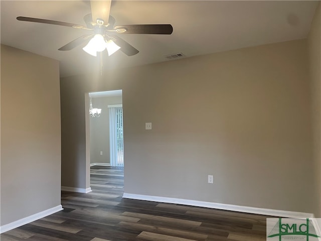 spare room with dark hardwood / wood-style floors and ceiling fan