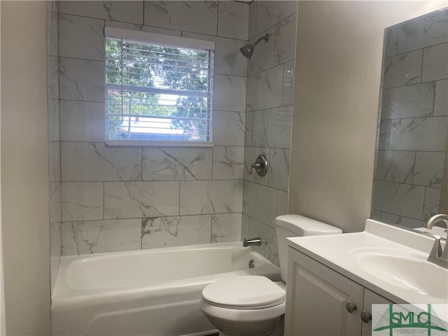 full bathroom with toilet, vanity, and tiled shower / bath