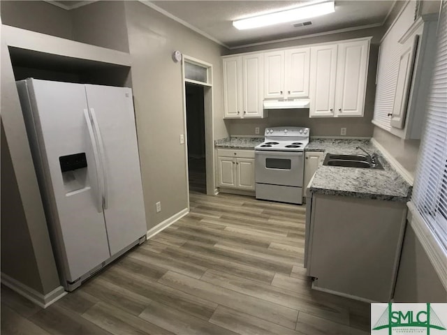 kitchen with white appliances, white cabinets, light stone countertops, hardwood / wood-style flooring, and ornamental molding