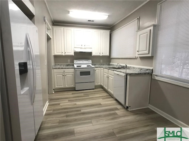 kitchen with white cabinetry, light wood-type flooring, white appliances, and light stone countertops