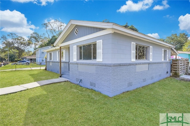 view of side of home featuring a lawn