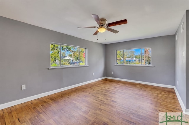 unfurnished room featuring hardwood / wood-style floors, plenty of natural light, and ceiling fan