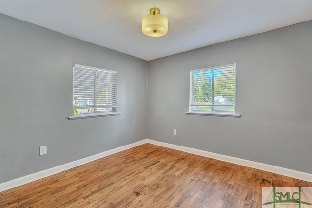 spare room with hardwood / wood-style floors