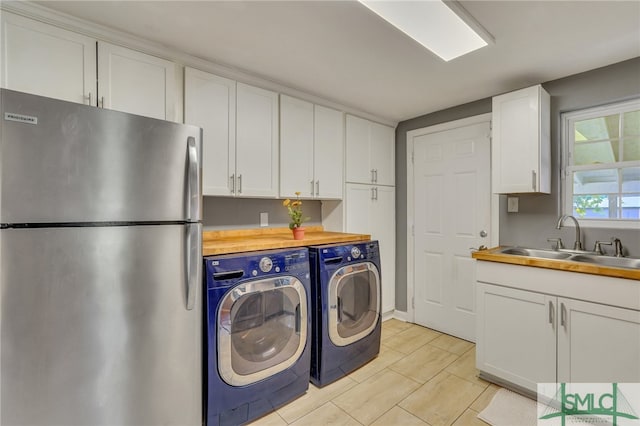 washroom with sink and separate washer and dryer