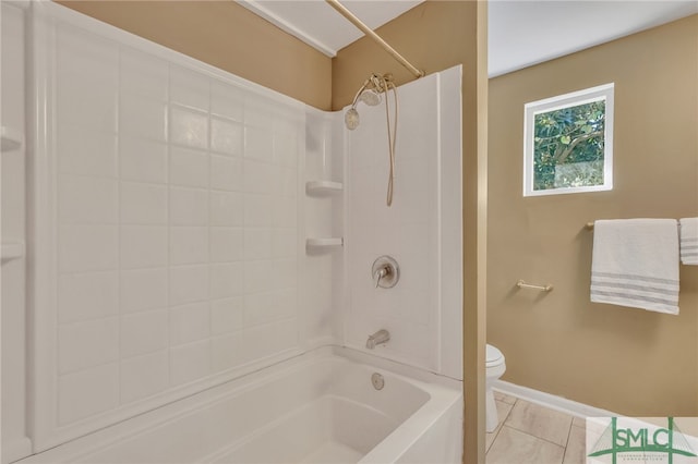 bathroom featuring toilet, tile patterned flooring, and tiled shower / bath