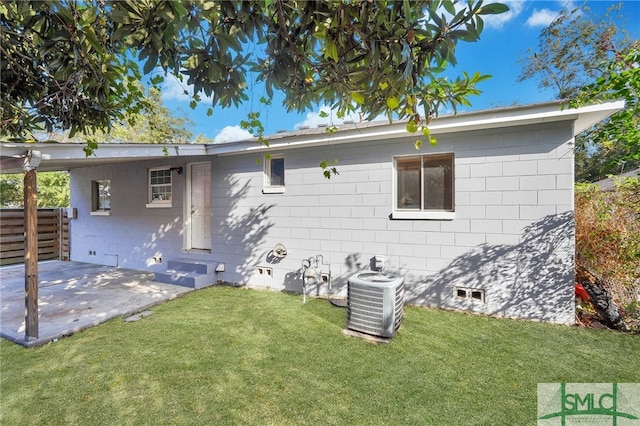 back of house with a patio, central AC, and a lawn