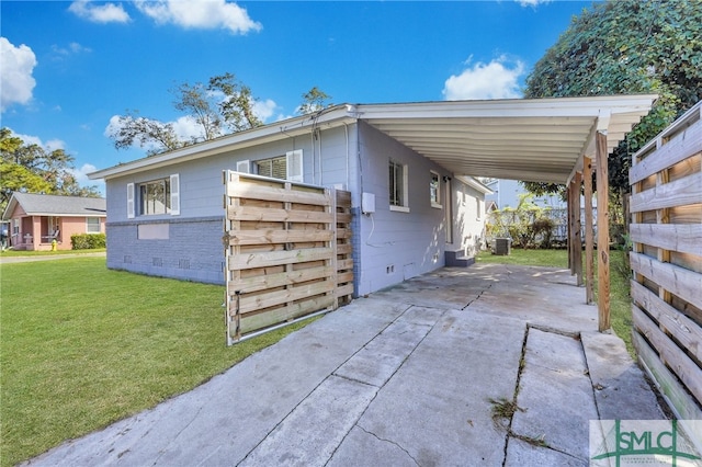 view of home's exterior with a lawn, central AC unit, and a carport