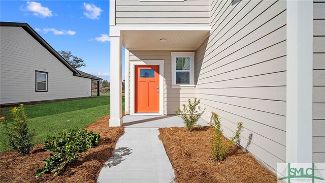 entrance to property with a yard